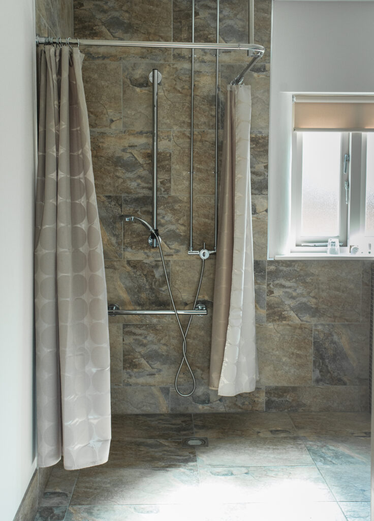 The en suite wet room is an accessible bedroom at Healing Manor Hotel