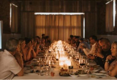 A warmly-lit, chapel style Barn set up for a private dining event.