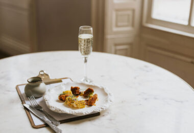 An example of a scallop dish from a Tasting Menu at The Pig & Whistle, Healing Manor on a Marble table, served in the restaurant.